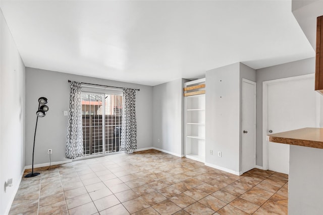 spare room with light tile patterned flooring