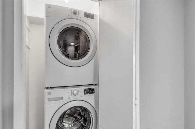 laundry room with stacked washer / drying machine