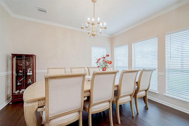 dining space featuring crown molding, dark wood-type flooring, visible vents, and a notable chandelier