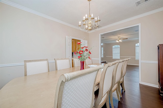 dining space with dark wood-style flooring, visible vents, ornamental molding, baseboards, and ceiling fan with notable chandelier