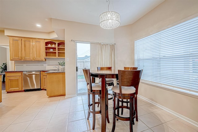 dining area with light tile patterned floors, recessed lighting, baseboards, and an inviting chandelier