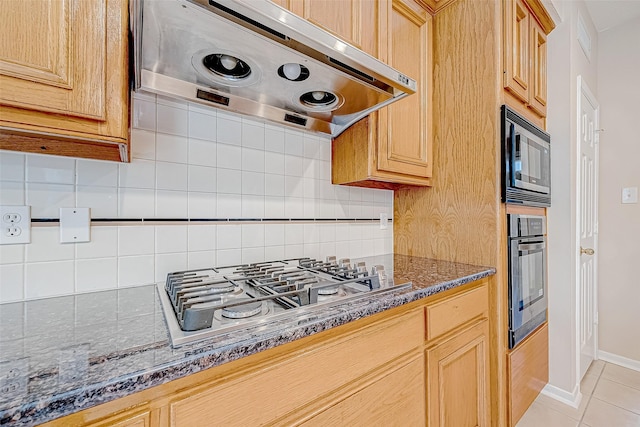 kitchen with light tile patterned floors, tasteful backsplash, oven, built in microwave, and stainless steel gas cooktop