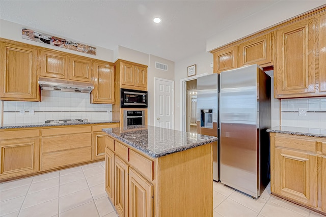 kitchen with stainless steel appliances, visible vents, under cabinet range hood, and light tile patterned flooring