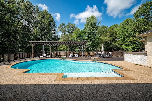 view of pool with a patio area, a pergola, and exterior bar