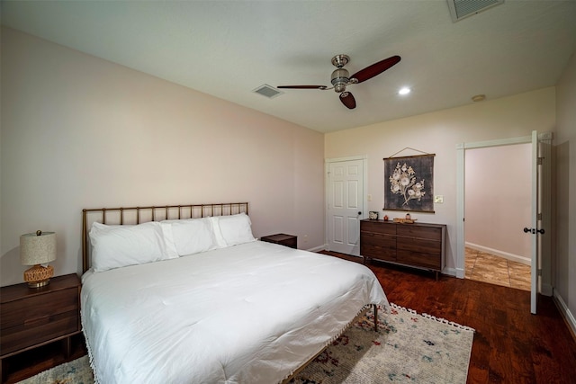 bedroom with ceiling fan and dark hardwood / wood-style flooring