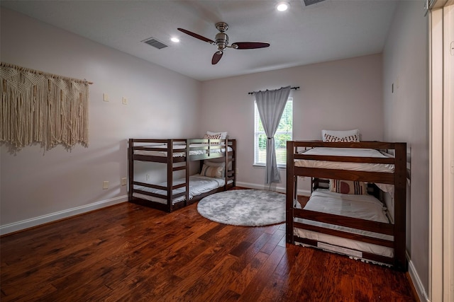 bedroom with ceiling fan and dark wood-type flooring