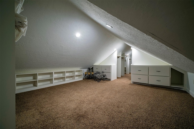 bonus room with carpet, a textured ceiling, built in features, and lofted ceiling