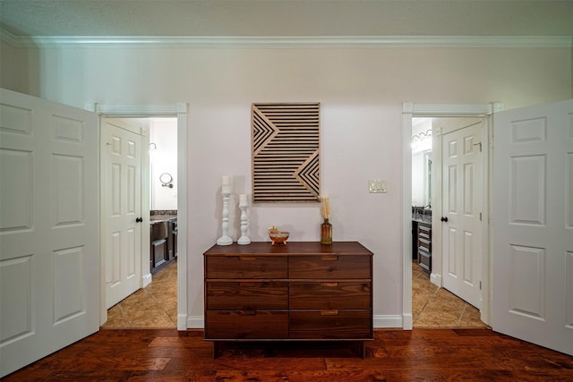 hall with dark hardwood / wood-style floors and ornamental molding