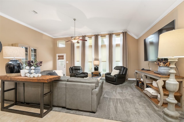 carpeted living room featuring ceiling fan, a healthy amount of sunlight, ornamental molding, and vaulted ceiling