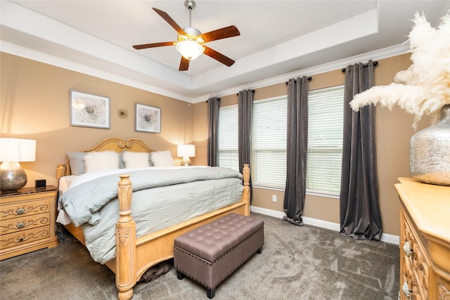 carpeted bedroom featuring a raised ceiling, ceiling fan, and ornamental molding