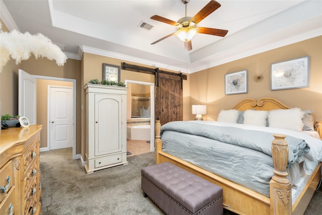 carpeted bedroom featuring ensuite bath, ceiling fan, a raised ceiling, a barn door, and crown molding