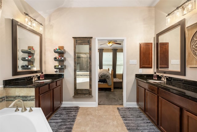 bathroom featuring vanity, a bathtub, tile patterned floors, and ceiling fan