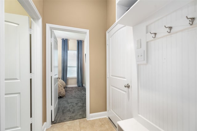 mudroom featuring light colored carpet