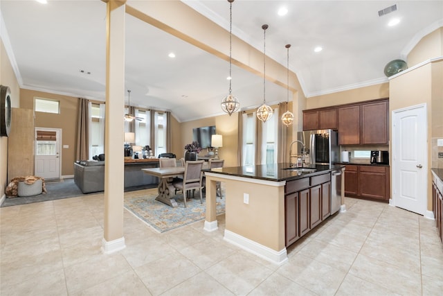 kitchen featuring crown molding, lofted ceiling, a kitchen island with sink, and stainless steel refrigerator with ice dispenser