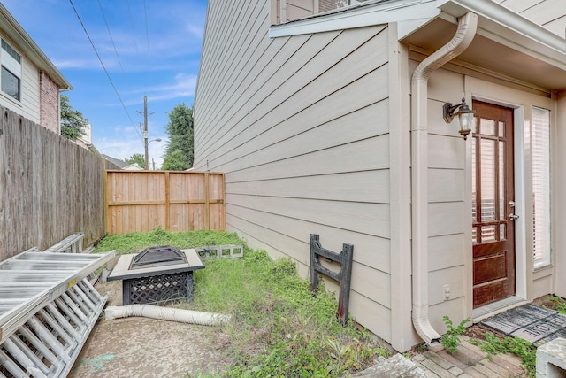 view of property exterior featuring an outdoor fire pit