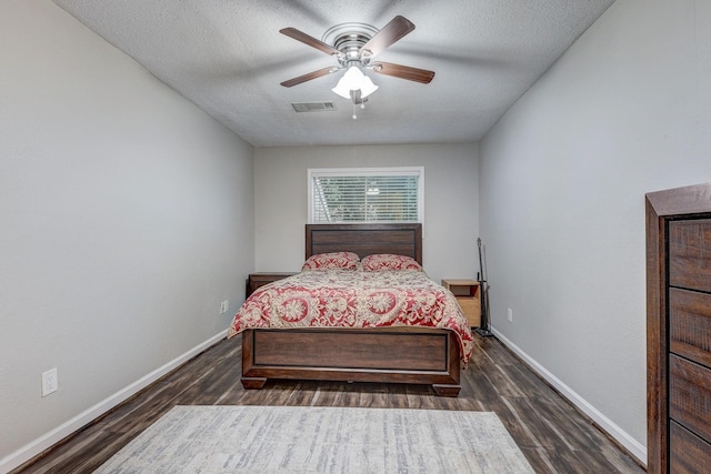 bedroom featuring a textured ceiling, ceiling fan, and dark wood-type flooring