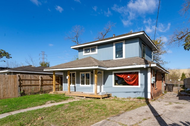 back of house with a porch and a yard