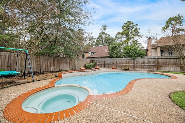 view of pool featuring an in ground hot tub