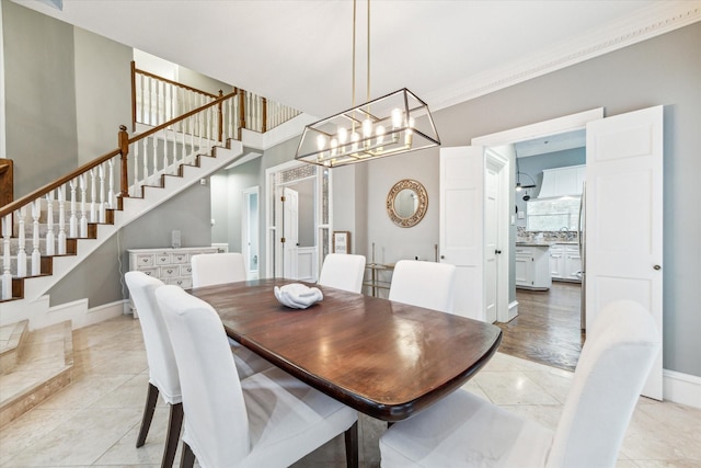 dining space with crown molding and light tile patterned floors