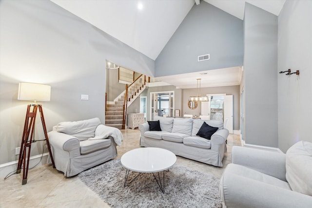 living room with high vaulted ceiling and an inviting chandelier