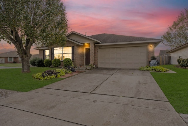 ranch-style home featuring a yard and a garage