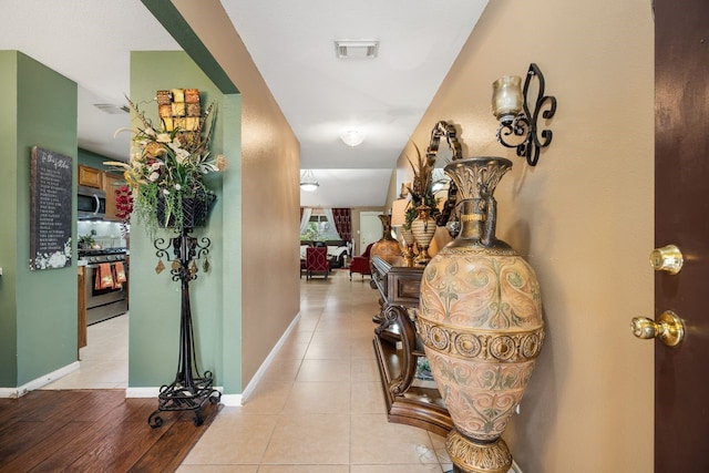 hallway featuring light tile patterned floors