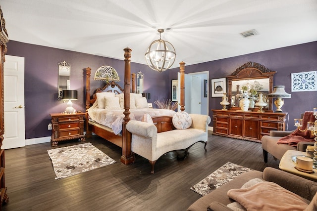 bedroom with dark wood-type flooring and a notable chandelier