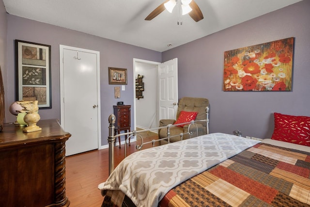 bedroom with hardwood / wood-style floors and ceiling fan