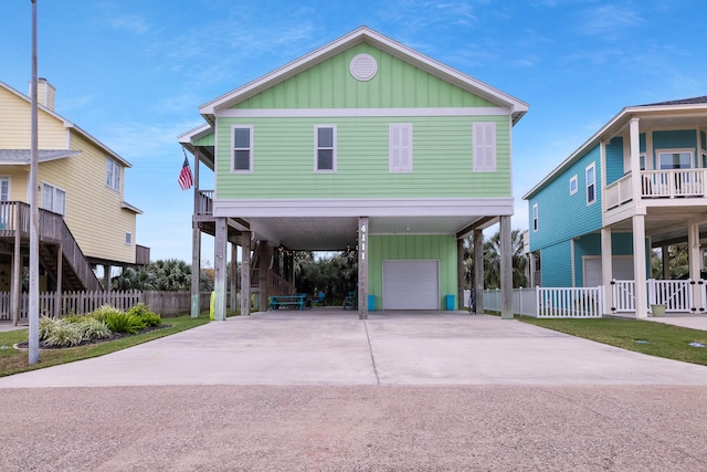 view of front of property featuring a garage and a carport