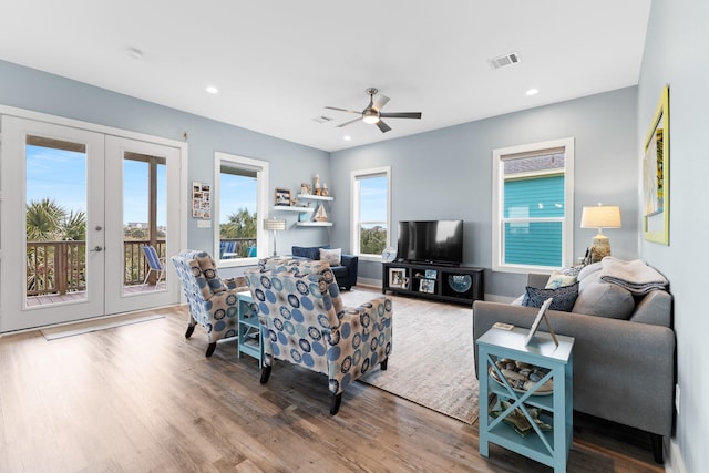 living room featuring ceiling fan, french doors, and hardwood / wood-style floors