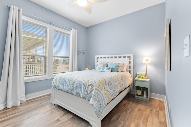 bedroom with ceiling fan and hardwood / wood-style flooring