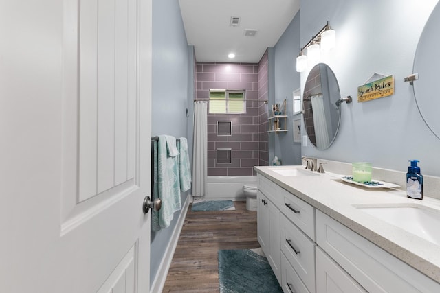 full bathroom with wood-type flooring, vanity, shower / bath combination with curtain, and toilet