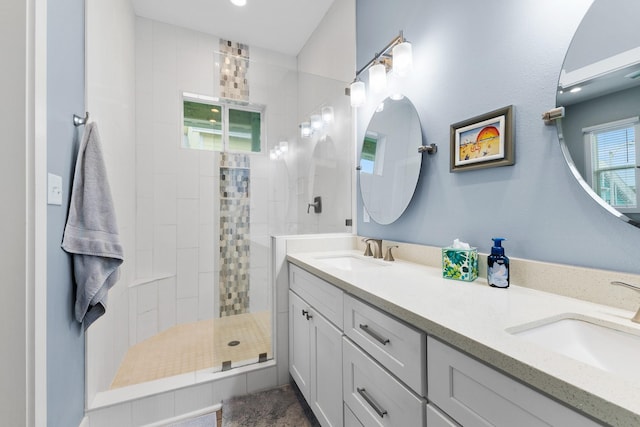 bathroom featuring vanity and tiled shower