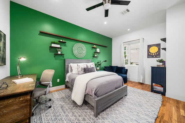 bedroom featuring hardwood / wood-style flooring and ceiling fan