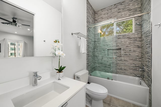 full bathroom featuring vanity, tile patterned flooring, ceiling fan, toilet, and combined bath / shower with glass door