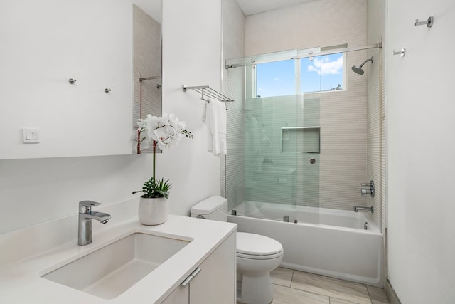 full bathroom with toilet, tile patterned flooring, combined bath / shower with glass door, and vanity