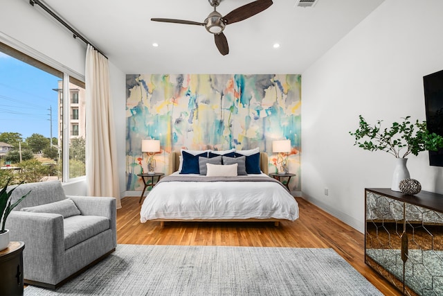 bedroom featuring hardwood / wood-style flooring and ceiling fan