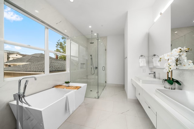 bathroom featuring shower with separate bathtub and vanity