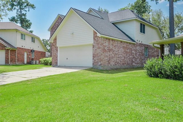 view of side of property with a garage, cooling unit, and a lawn