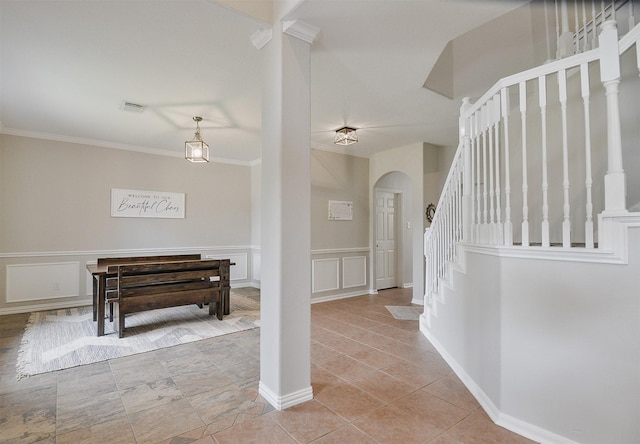 entrance foyer with light tile patterned flooring and crown molding