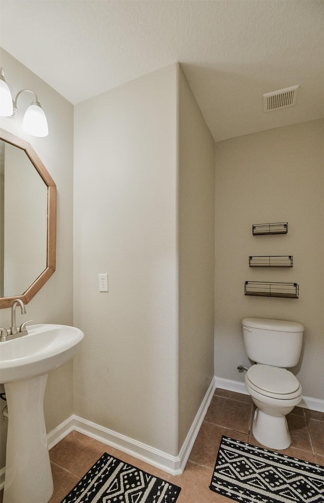 bathroom featuring tile patterned floors and toilet