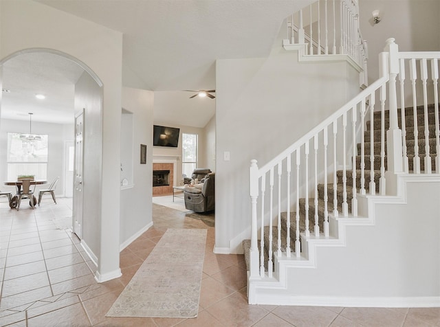 entrance foyer with a tile fireplace and light tile patterned floors