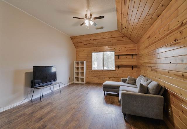 living room with lofted ceiling, wood walls, ceiling fan, and dark hardwood / wood-style floors