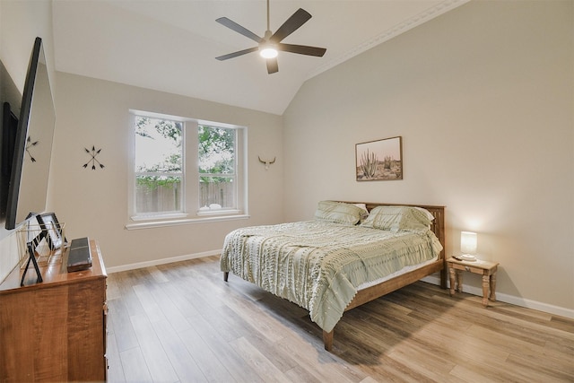 bedroom with ceiling fan, lofted ceiling, and light hardwood / wood-style flooring