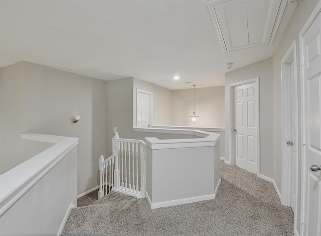 hallway with light colored carpet