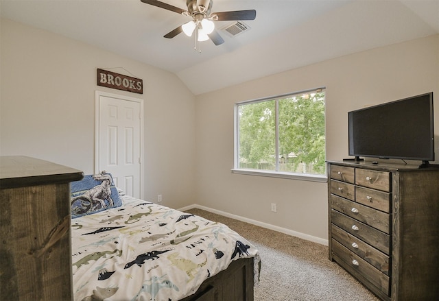 carpeted bedroom with vaulted ceiling and ceiling fan