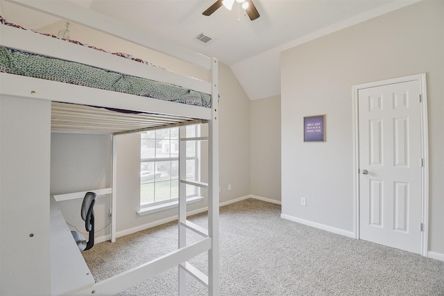 unfurnished bedroom with carpet floors, vaulted ceiling, and ceiling fan