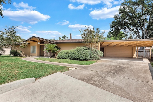 ranch-style house featuring a front yard, a garage, and a carport