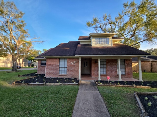 view of front of house with a front yard and a porch