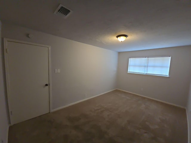 unfurnished room with carpet flooring